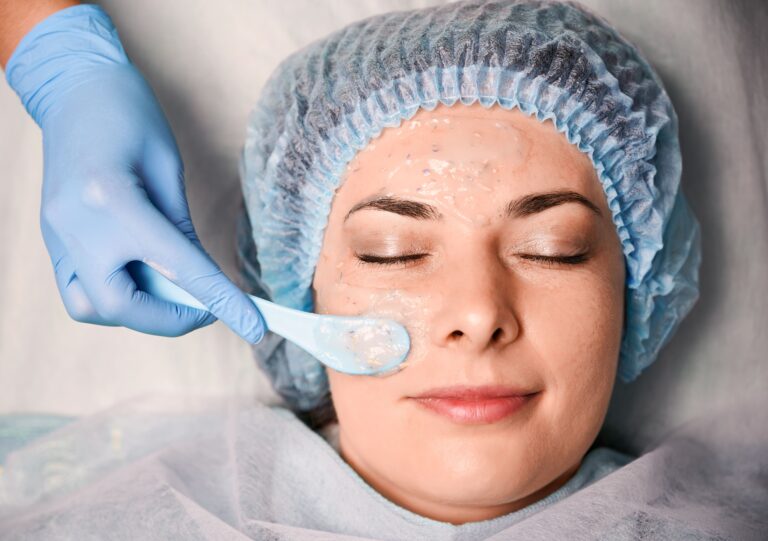 cosmetologist-hand-applying-cosmetic-mask-woman-face (1)